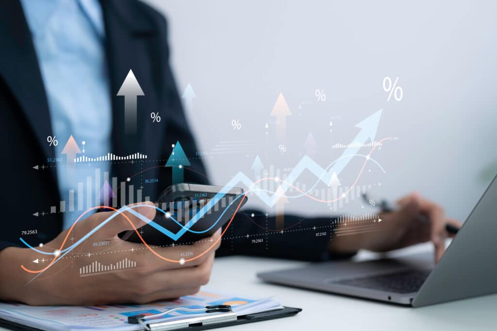 Business professional analyzes tax VAT data on smartphone and laptop in office using financial charts for accounting compliance reporting and digital finance management strategy